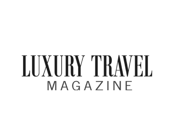 The logo for 'LUXURY TRAVEL MAGAZINE' in black serif and sans-serif lettering on a solid white background.