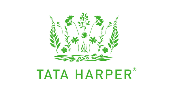 Tata Harper logo in green, featuring a botanical crest above the brand name on a plain white background.